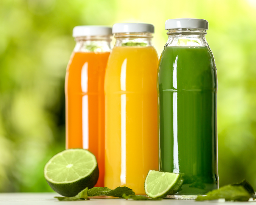 glass bottles filled with fruit juice